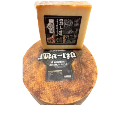 Fetta di Pecorino stagionato MA-TRÙ del Caseificio Storico di Amatrice su tagliere